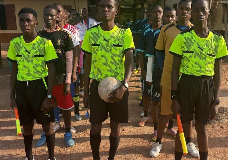 Bidii Schools students in sports kit lined up on the playing field for athletics