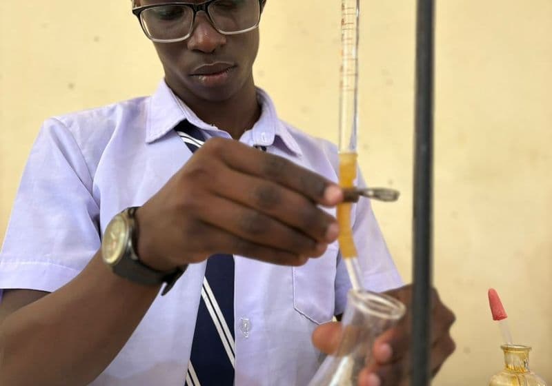 A student performing a titration experiment in the Bidii Schools chemistry laboratory