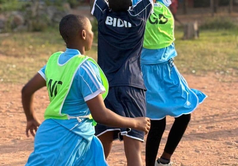 Students leaping for the ball during a netball or basketball game at Bidii Schools