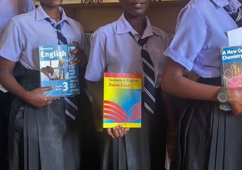 Students holding their textbooks in the Bidii Schools library