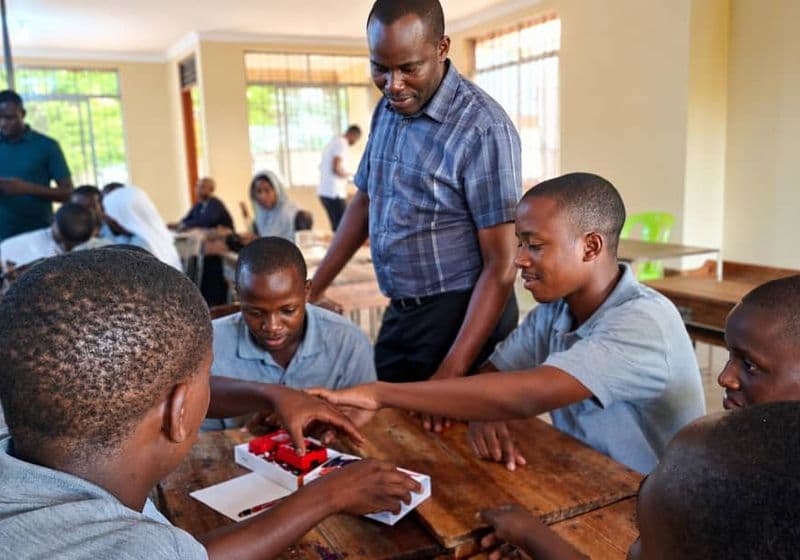 A teacher guiding students through a science kit activity at Bidii Schools