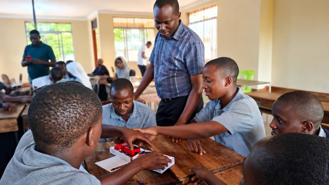 A teacher guiding students through a science kit activity at Bidii Schools