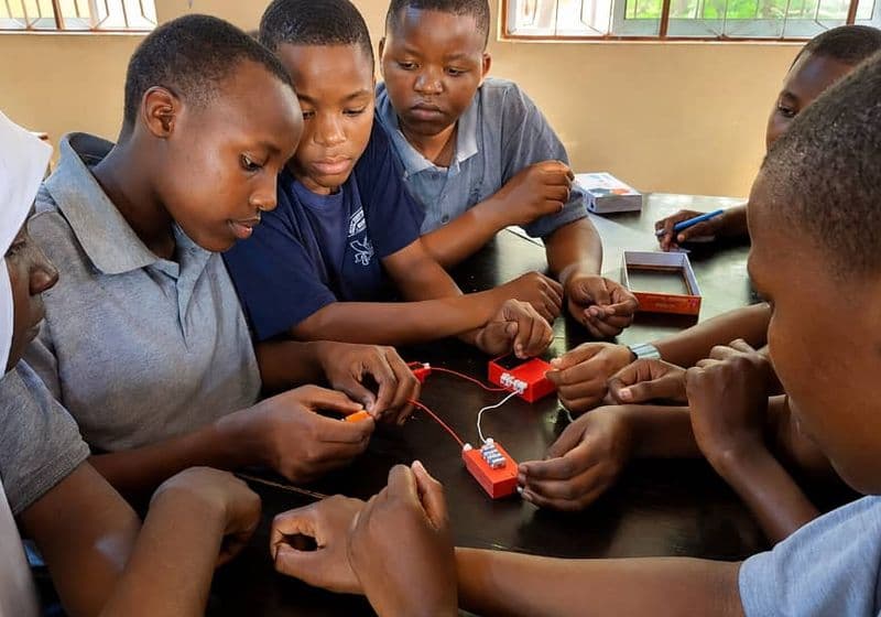 Students collaborating on an electronics circuit kit during a STEM session at Bidii Schools
