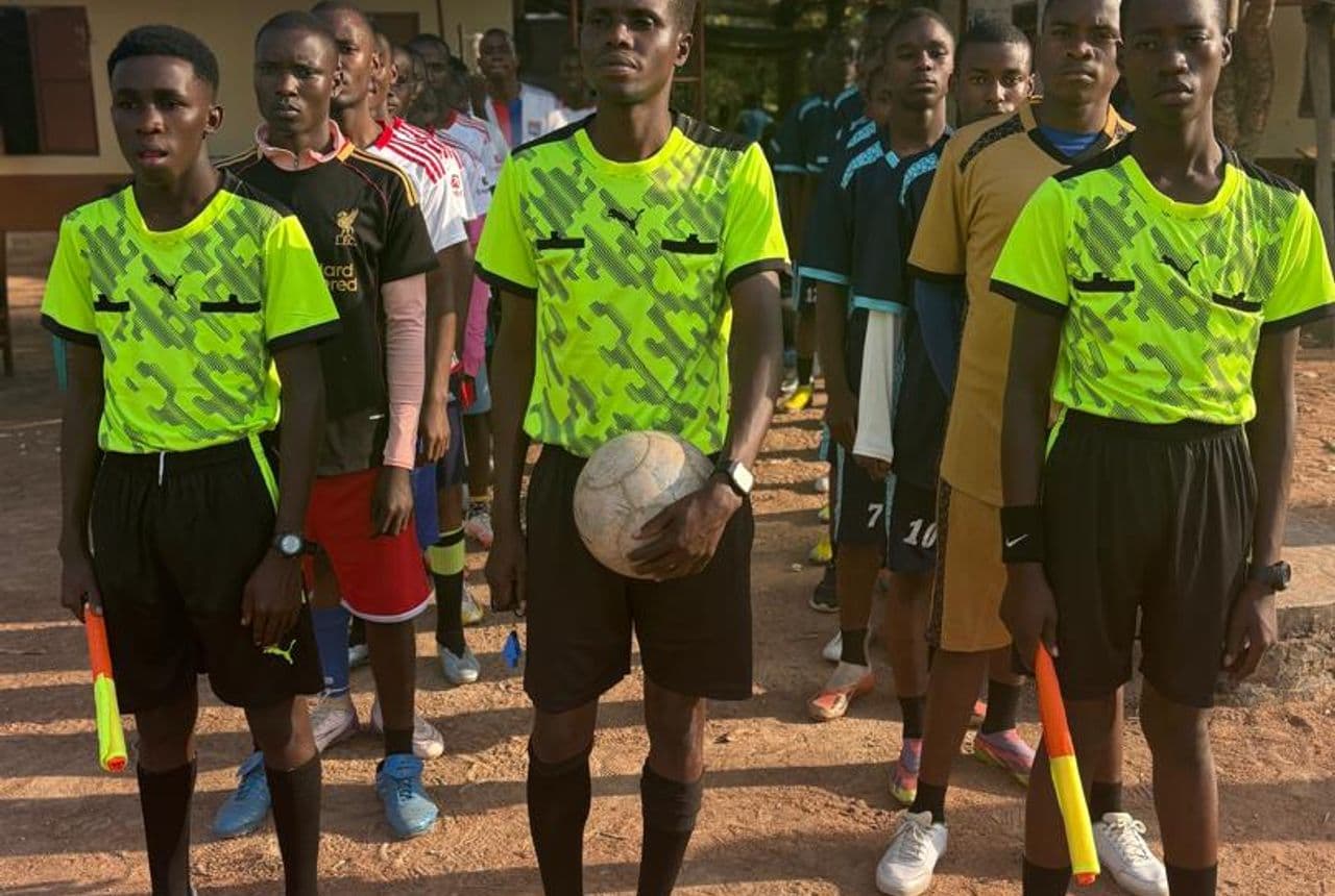 Bidii Schools students in sports kit lined up on the playing field for athletics