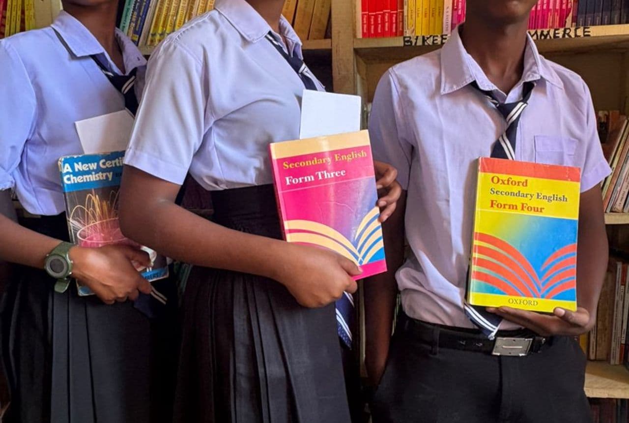 Students reading quietly among the shelves in the Bidii Schools library